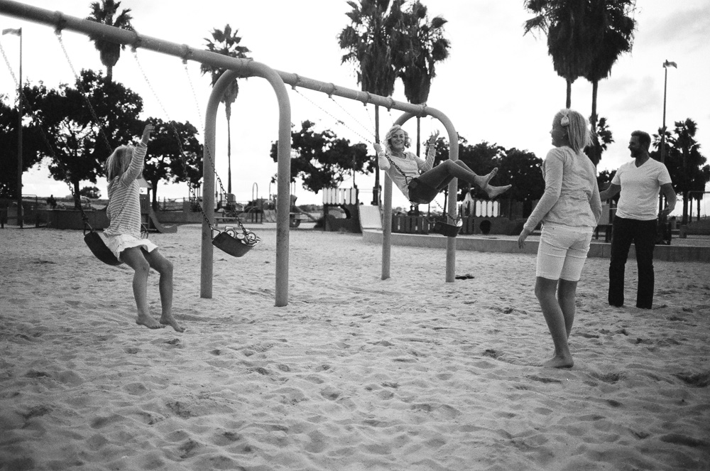 Family mistiming a coordinated jump from park swings, again. ©William Bay Photographic Arts.