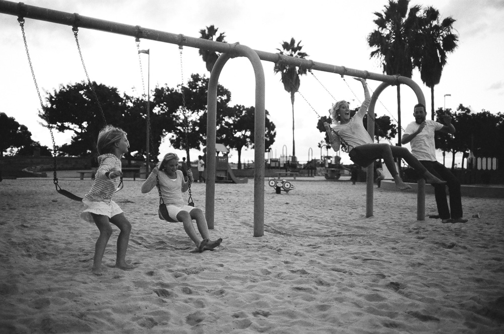 Family mistiming a coordinated jump from park swings. ©William Bay Photographic Arts.